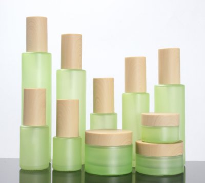 Green frosted glass spray bottle with wooden cap